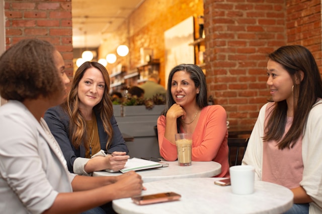 Women professionals networking at a business event with coffee and conversation