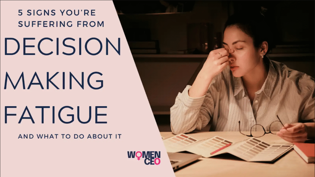 A woman up late holding the bridge of her nose, suffering from decision making fatigue