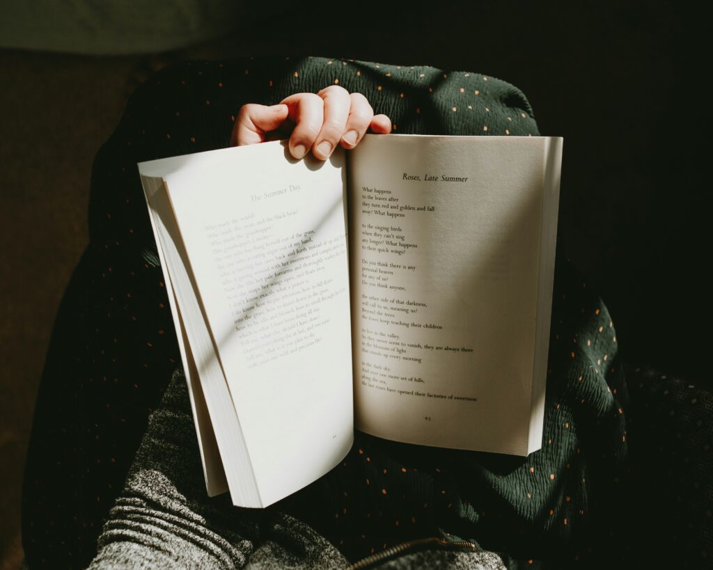 woman holding up a book of inspirational quotes from women ancestors