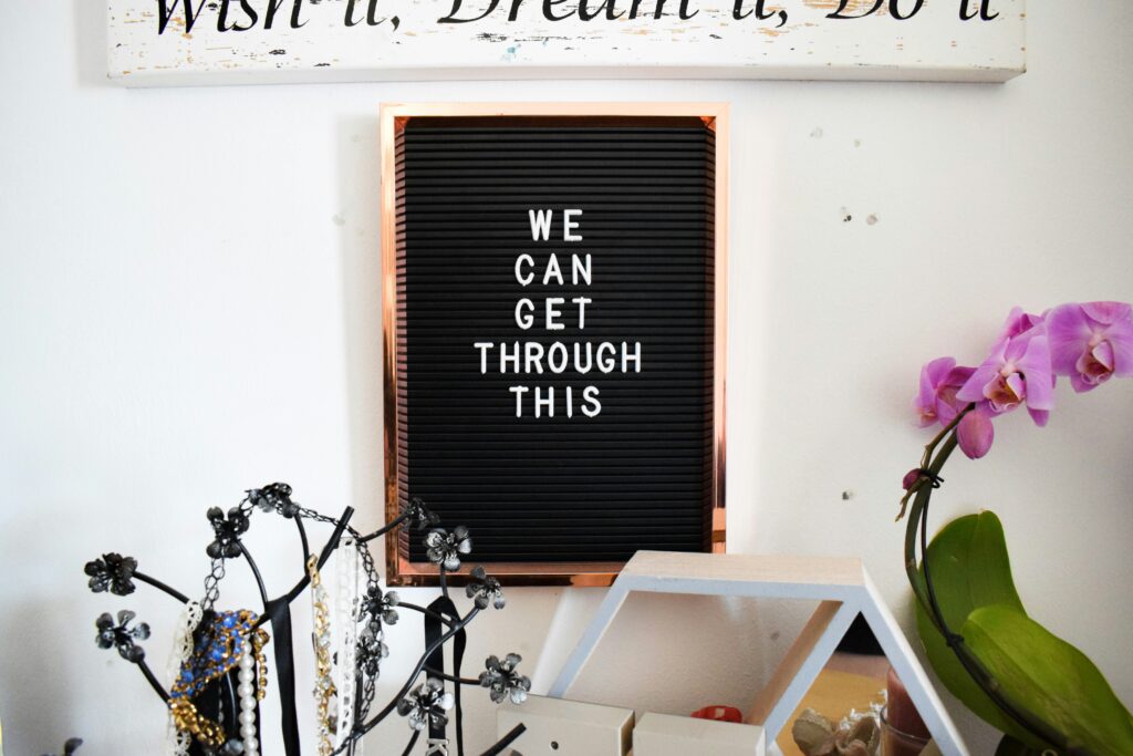 Strong lady quotes displayed on wall - "We can get through this" serves as powerful women quotes for daily strength