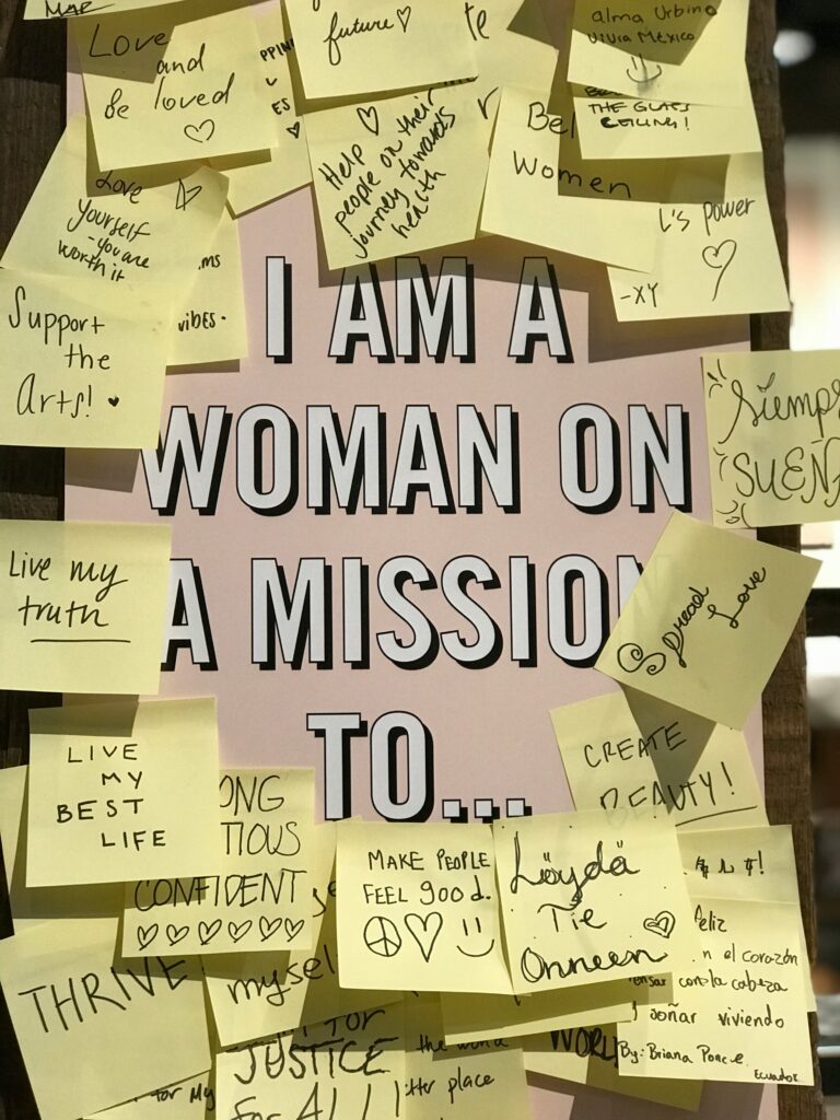 Women motivational quotes on sticky notes surrounding strong woman quotes declaring "I am a woman on a mission to succeed"