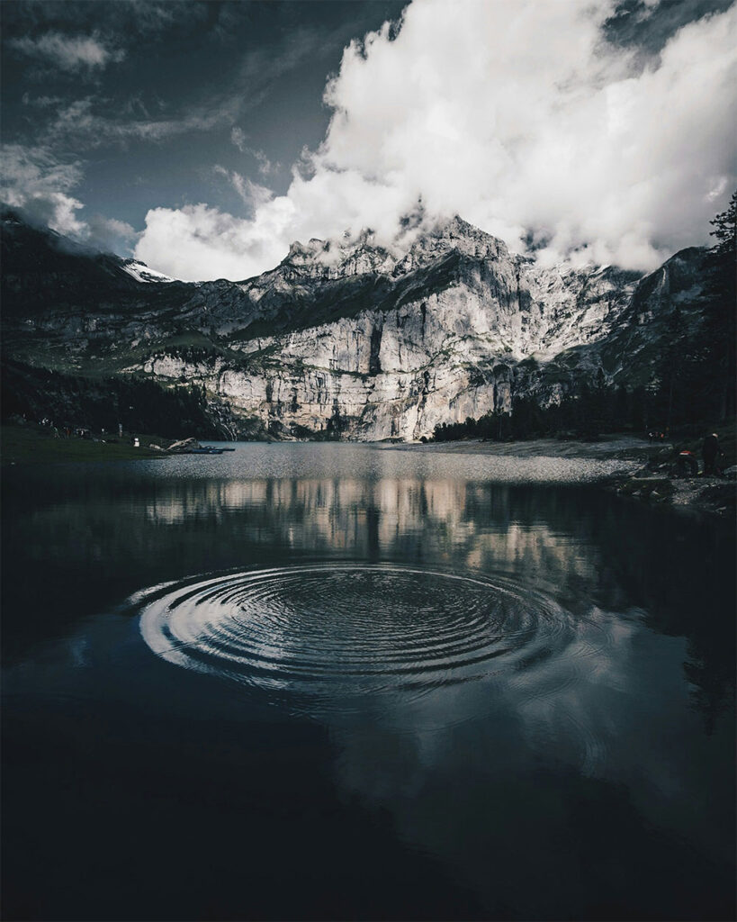 Economic ripple effect visualization representing entrepreneurs impact on society spreading across mountain landscape, representing widespread community benefits