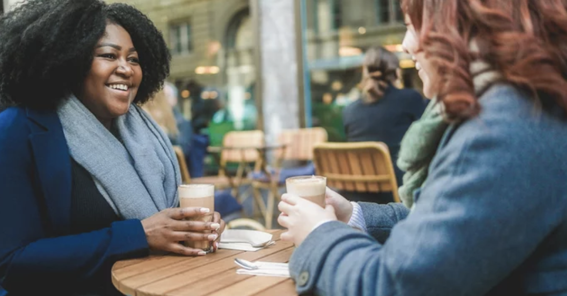 Two women discussing goals with an accountability partner, showing the importance of connection and support