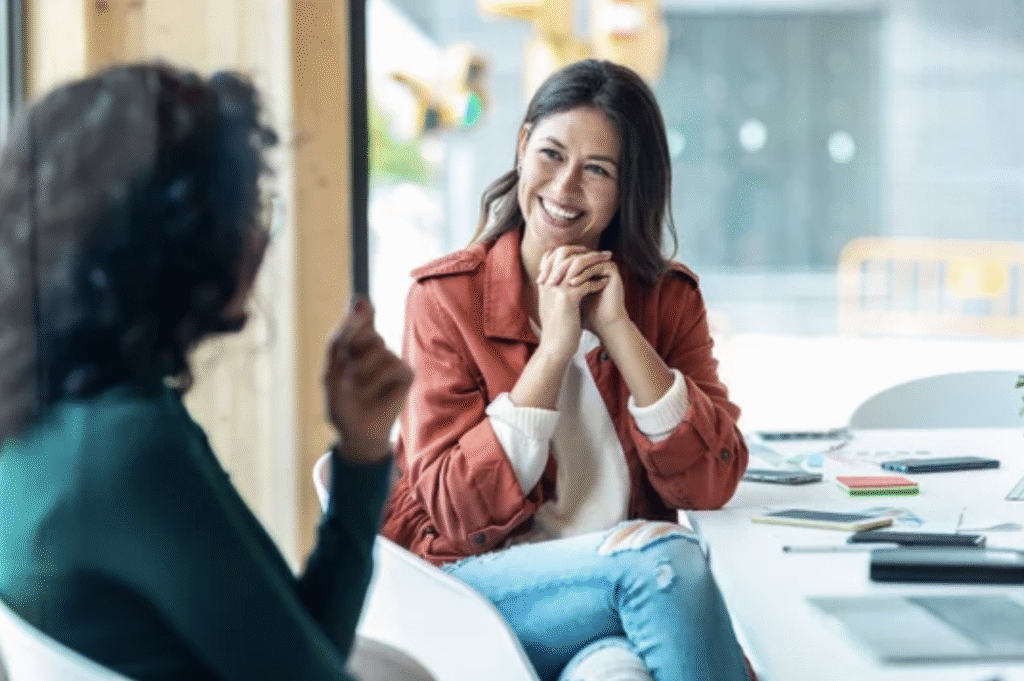 Women talking at a meeting while reviewing effective networking metrics